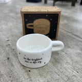 Ceramic T-Light Holder with loving quote: 'Be the brightest star in the sky' Lovely small gift idea for that special someone to show them you are thinking about them in a simple yet beautiful way. Decorated with mini stars all around and a handle at the side. 