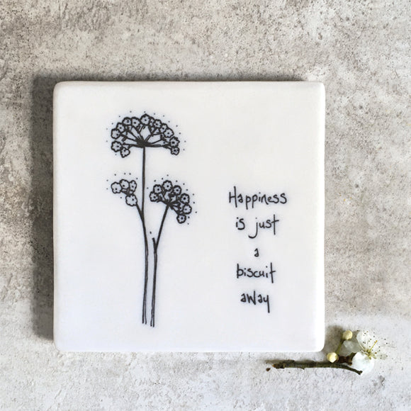 East of India 178 -Quotable Coaster for someone special; ‘Happiness is just a biscuit away' Porcelain square white floral coaster with the thoughtful words.