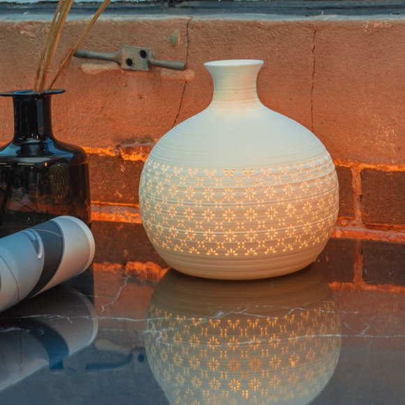 Light Glow White Ceramic Lamp - Round Jar Vase A table lamp in a jar vase shape with a perforated design of daisy-inspired motif.