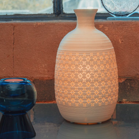 Light Glow White Ceramic Lamp - Long Jar Vase A table lamp in a jar vase shape with a perforated design of daisy-inspired motif.