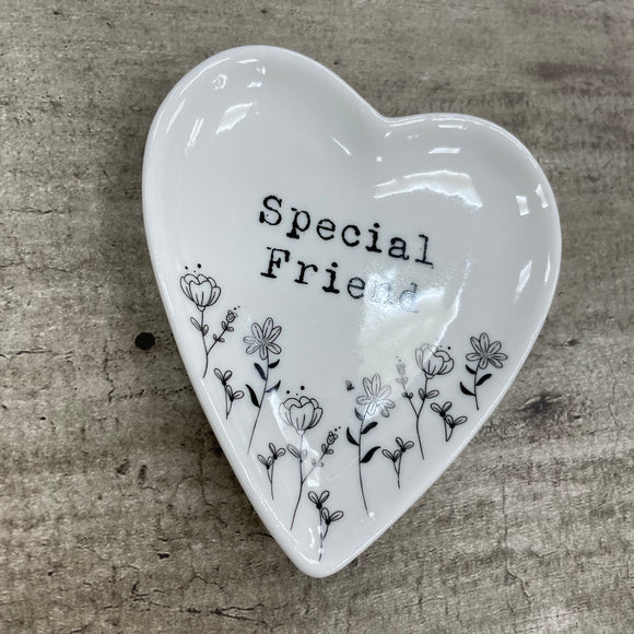 White ceramic heart trinket dish with floral detailing around the heart and written inside is the words 'Special Friend'. 10x9cm