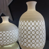 Light Glow White Ceramic Lamp - Long Jar Vase A table lamp in a jar vase shape with a perforated design of daisy-inspired motif.