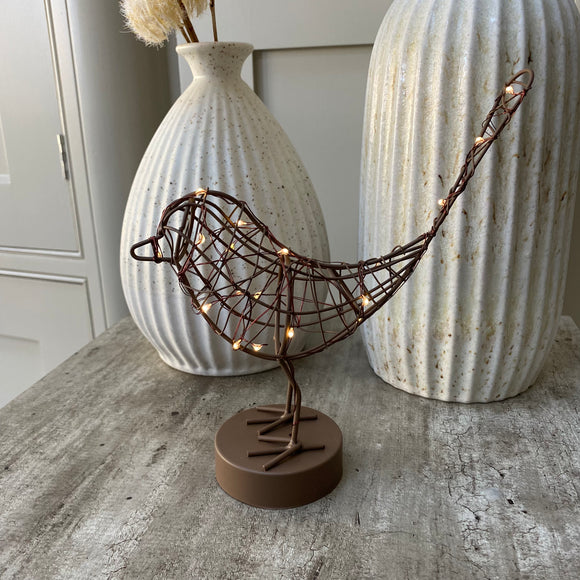 A gorgeous caged antique brown/copper Robin wrapped in 20 warm white LEDs, stood on a round block. Stunning accessory for the home that transforms from day to night, looks great displayed on a shelf or windowsill.