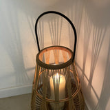 A stylish detailed bamboo lantern with a black metal handle and a glass insert to place a pillar candle or lights in the centre creating a warm, natural decoration for your home or garden.