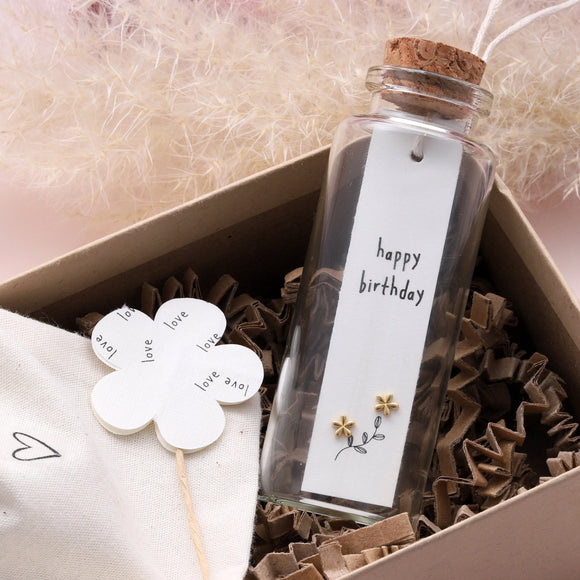 Attic Creations - giftings life's precious moments since 2010;    Message in a Bottle Sterling Silver Earrings handmade in Devon Style - Silver flower shaped stud earrings Quote on the card - 'Happy Birthday'