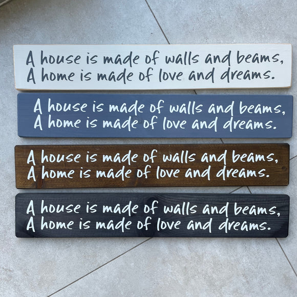 Made in the UK by The Giggle Gift co. Long L59.5cm Wooden Hanging Plaque; A house is made of walls and beams, A home is made of love and dreams.