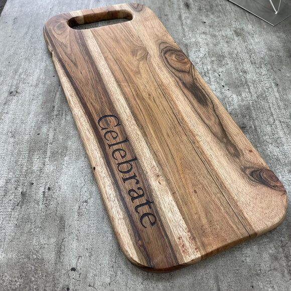 Wooden long chopping board with handle and quote Celebrate emotive  on board