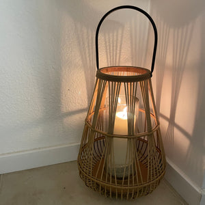 A stylish detailed bamboo lantern with a black metal handle and a glass insert to place a pillar candle or lights in the centre creating a warm, natural decoration for your home or garden.