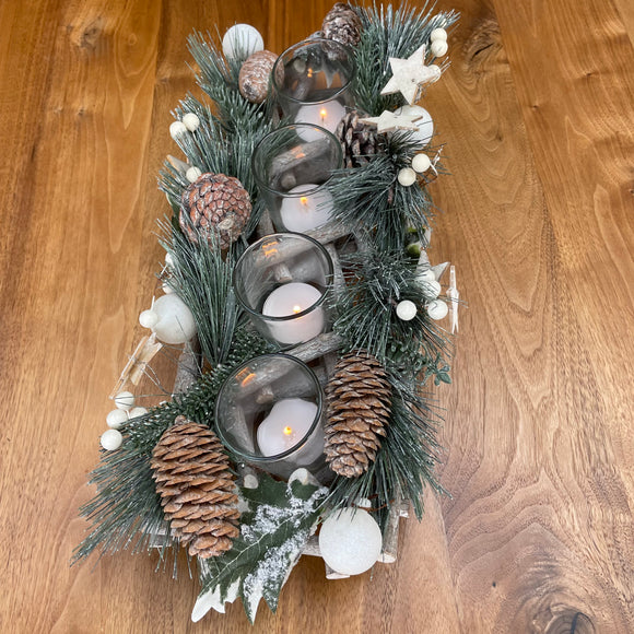 Whitewash Branch 39cm long candle holder, decorated with pine, pinecones, white small baubles & white berries with 4 t-light holders sat inside. Has white glitter touch to give it a frosty look.  Dimensions: H9 x L39 x W14cm 