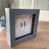 Mini Framed Pebble Art - Grey block square frame 12.5cmWith a soft background image of a pink heart and two pebble people standing inside it holding hands with a bunch of pink flowers with the quote 'The love between a Mother & Daughter is forever' 