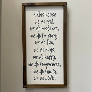 Made in the UK by Giggle Gift Co Rectangular L64cm Framed Plaque with Off White vinyl; "In this house we do real, we do mistakes, we do I'm sorry, we do fun, we do hugs, we do happy, we do forgiveness, we do family, we do LOVE."