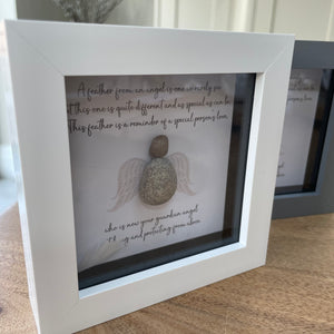 Mini Framed Pebble Art - White & Grey block square frame 12.5cm 'A feather from an angel is one we rarely see but this one is quite different and as special as can be. This feather is a reminder of a special person's love , who is now your guardian angel watching and protecting from above'The pebble angel with the wings in a soft background with a white feather loose inside the frame making this a beautiful gift