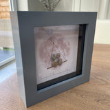 Mini Framed Pebble Art - Grey block square frame 12.5cm;With a soft background image of the world and a swing seat with two pebble people: you and your dad sitting together with the quote 'Dad' at the top in a blue heart and at the bottom 'I love you to the moon and back'