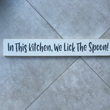Long Wooden Hanging Sign - 'In This Kitchen, We Lick The Spoon!'