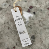 Sweet knot shaped stud earrings presented in a message bottle on a card that reads "our friendship is a knot”  Sterling Silver 