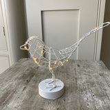 A gorgeous caged white Robin wrapped in 20 warm white LEDs, stood on a round block. Stunning accessory for the home that transforms from day to night, looks great displayed on a shelf or windowsill.