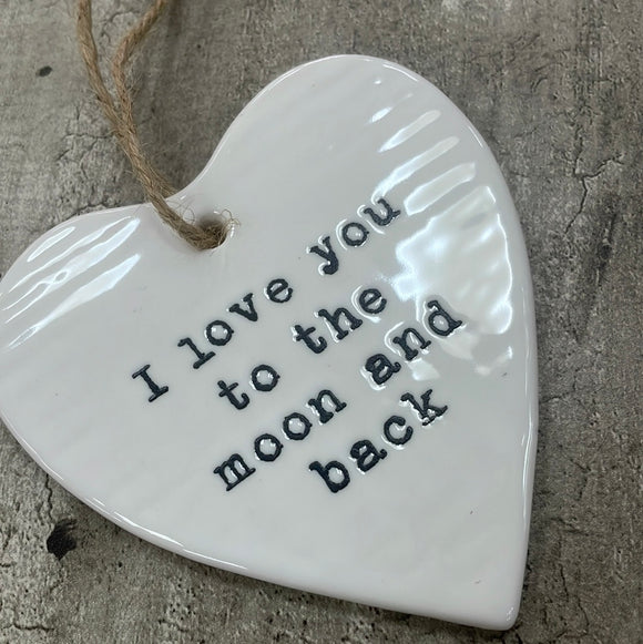 White ceramic hanging heart 10cm with a loving quote; 'I love you to the moon and back'