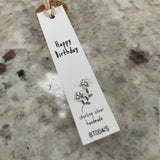 Sweet flower shaped stud earrings presented in a message bottle on a card that reads "happy birthday"  Sterling Silver