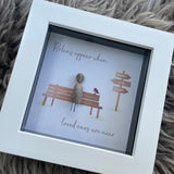 Mini Framed Pebble Art -White block square frame 12.5cmThis frame has the image of directional sign saying 'always in my heart' and a bench with a pebble person sitting on it with a robin and the quote 'Robins appear when loved ones are near'